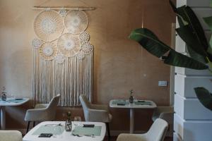 a dining room with two tables and chairs at NOMA LUXURY BeB in Aversa
