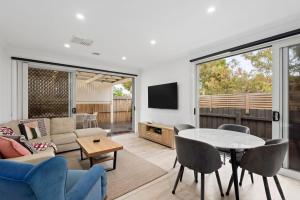 a living room with a couch and a table at Latte's Nest in Point Lonsdale