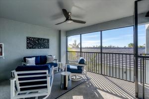 a living room with a ceiling fan and a balcony at HLB14224-922 in Burnt Store Marina