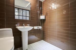 a bathroom with a sink and a toilet at Avenue Hotel in Osan