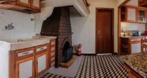 a kitchen with a brick fireplace in a room at BABhouse Lagar Antigo - Coração do Douro in Nagoselo do Douro +20 photos