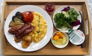 a tray with two plates of breakfast food on it at 9 Brick Hotel in Seoul