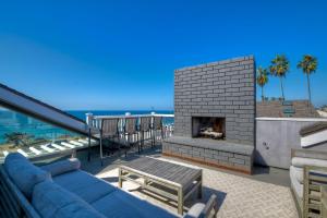 a living room with a blue couch and a fireplace at 3636 Carlsbad Blvd - Upper in Carlsbad