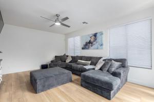 a living room with a gray couch and a fan at San Michelle Luxury Escape Mesa Pr1348 in Mesa +56 photos