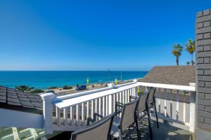 a balcony with chairs and a view of the ocean at 3636 Carlsbad Blvd - Upper in Carlsbad