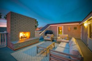a living room with a fireplace on a patio at 3636 Carlsbad Blvd - Upper in Carlsbad +35 photos