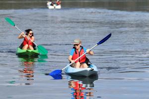 two women are kayaking on a body of water at Grantys House in Merimbula