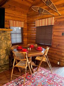 a dining room with a table and chairs in a cabin at Chair 9 Chalet in Big Bear Lake