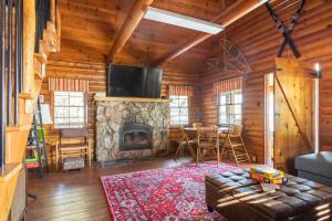 a living room with a fireplace in a log cabin at Chair 9 Chalet in Big Bear Lake