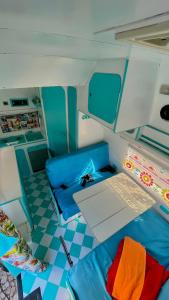 a small room with blue seats and a table in an rv at Campervan Dory in Lisbon