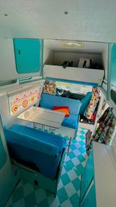 a small room with blue chairs and a table at Campervan Dory in Lisbon