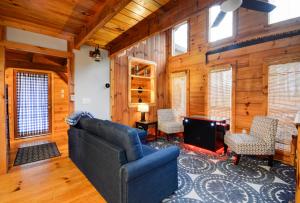 a living room with a couch and a tv at Whispering Winds in Rogers