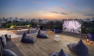 um pátio no último piso com mobiliário e vista para a cidade em Raízes Tucuruvi Studios em São Paulo