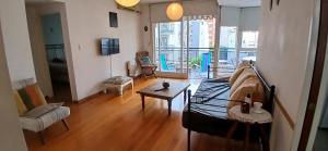 a living room with a couch and a table at Oasis en Belgrano in Buenos Aires