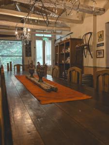 a room with a table with a rug on the floor at Posada Niña Juana in Villa Dolores