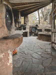 an outdoor patio with a stone fireplace and an outdoor oven at Posada Niña Juana in Villa Dolores
