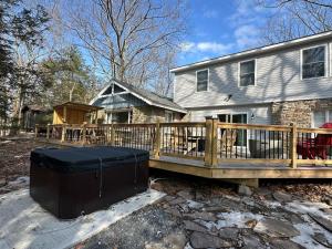 a wooden deck in front of a house at NewReno 8BR 6BTH DECK GAMES PETS in Lake Harmony
