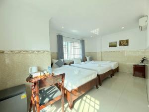 a large bedroom with two beds in a room at White Corner Hotel in Phnom Penh +102 photos