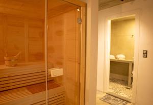 a walkin shower with a glass door in a bathroom at Palmyra Villas Luxury in Kamilari