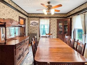 ein Esszimmer mit einem Tisch und einem Deckenventilator in der Unterkunft Kurtz Cottage - Y856 in York