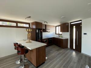 a large kitchen with a island in the middle at Pingel Home Vista Mar in Valparaíso