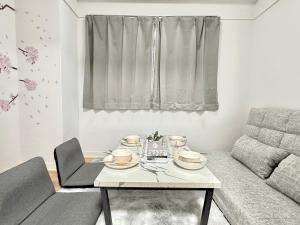 a living room with a table and a couch at Shinjuku Waseda home4 in Tokyo