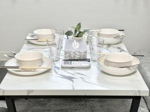 a white table with bowls and plates on it at Shinjuku Waseda home4 in Tokyo +32 photos