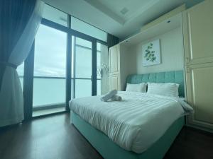 a bedroom with a bed with a teddy bear on it at Riverson Soho Luxury Stay by Finest Homestay in Kota Kinabalu +43 photos
