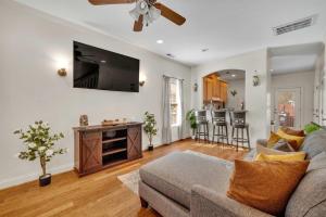 a living room with a couch and a flat screen tv at Cozy 2B Townhouse - King Bed in Concord