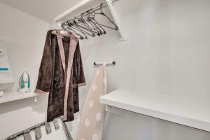 a white bathroom with a white counter and a shelf at Cozy 2B Townhouse - King Bed in Concord