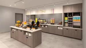 a large kitchen with a counter in a restaurant at Home2 Suites By Hilton in Hernando
