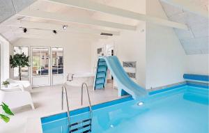 a house with a swimming pool and a slide at Stunning Home In Ulfborg With Sauna in Ulfborg