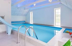 a swimming pool with a slide in a house at Stunning Home In Ulfborg With Sauna in Ulfborg