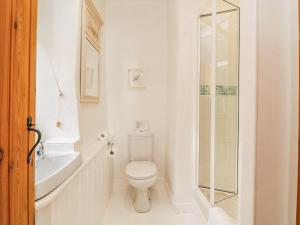 a white bathroom with a toilet and a sink at Clamoak Cottage in Yelverton +34 photos