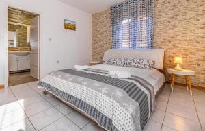 a bedroom with a bed and a brick wall at Awesome Apartment In Medulin With Wifi in Medulin