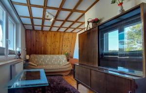 a living room with a couch and a large window at Awesome Home In Stezyca With Wifi in Stężyca +14 photos