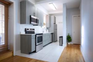 a kitchen with a stove and a microwave at Fordham University in University Heights