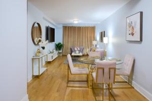 a living room with a glass table and chairs at Fordham University in University Heights