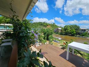 a balcony with a view of a river at NatureHome RimKhlong in Ban Bang Rin (1)