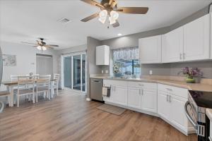 a kitchen with white cabinets and a ceiling fan at DBD1014 in Port Charlotte +41 photos