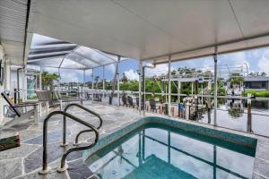 a swimming pool with tables and chairs next to a building at BRC18614 in Port Charlotte