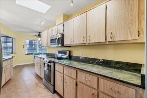 a kitchen with wooden cabinets and a large counter top at BRC18614 in Port Charlotte
