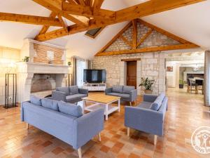 a living room with couches and a fireplace at Séjourner au cœur de la nature entre Tours et Angers - FR-1-622-101 in Saint-Philbert-du-Peuple