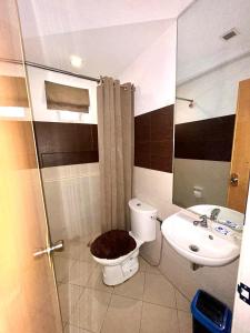 a bathroom with a toilet and a sink at VIP 4-Bedroom House in Butuan