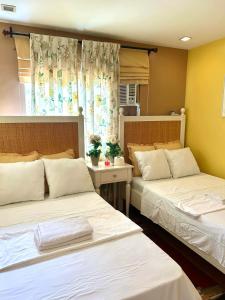 a room with two beds and a window at VIP 4-Bedroom House in Butuan