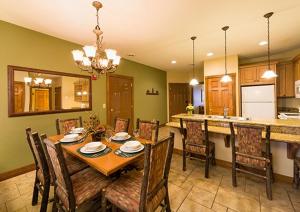 a dining room with a table and chairs and a kitchen at 1 BR Westgate Resort Sleeps 4 in Gatlinburg