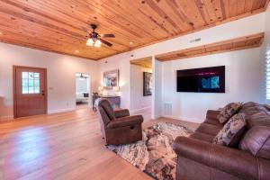 a living room with a couch and a ceiling fan at Sequoia Homestead in Kanab Pets OK Heated Pool in Kanab +34 photos