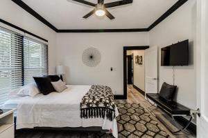 a bedroom with a bed and a flat screen tv at The Palm House Near Lake Hollingsworth & FSC in Lakeland