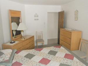 een slaapkamer met een bed, een dressoir en een bureau bij Sea Breeze W007 Wonderful Beachfront Oceanfront property for the whole family 1897 in Wells