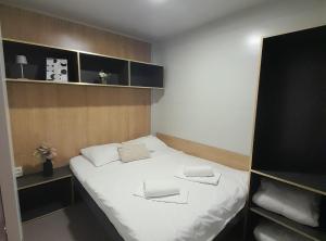 a bedroom with a bed with two towels on it at Gabrijela House in Pirovac